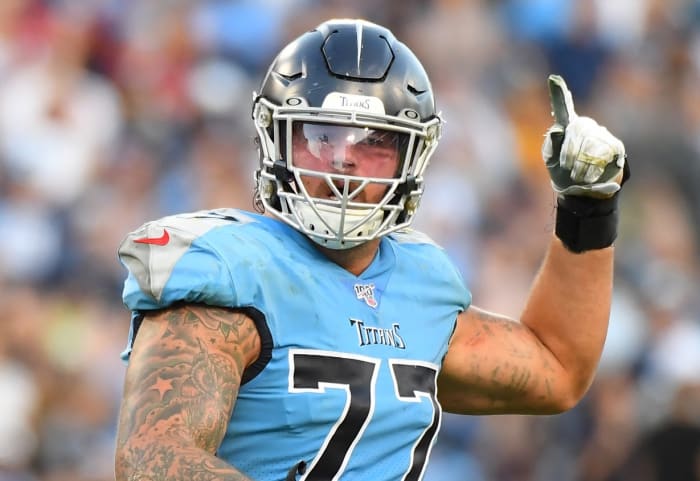 Tennessee Titans offensive tackle Taylor Lewan (77) celebrates after a touchdown during the second half against the Los Angeles Chargers at Nissan Stadium.